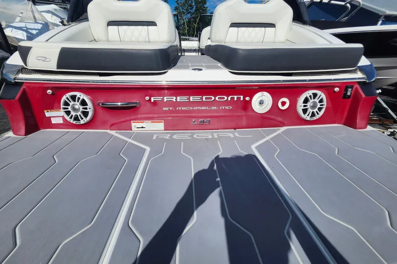 Slide: The Image of 2022 Regal LS6 boat rear view with speakers and seating, featuring "Freedom" branding. - 5