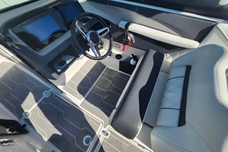 Slide: The Image of 2022 Regal LS6 boat interior with modern dashboard and luxurious seating. - 16