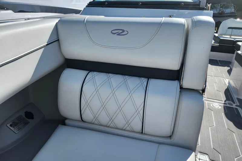 Slide: The Image of 2022 Regal LS6 boat interior with white leather seating and diamond stitching. - 22
