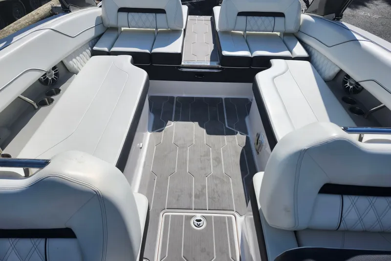 Slide: The Image of Interior of a 2022 Regal LS6 boat with luxurious white seating and modern design. - 26