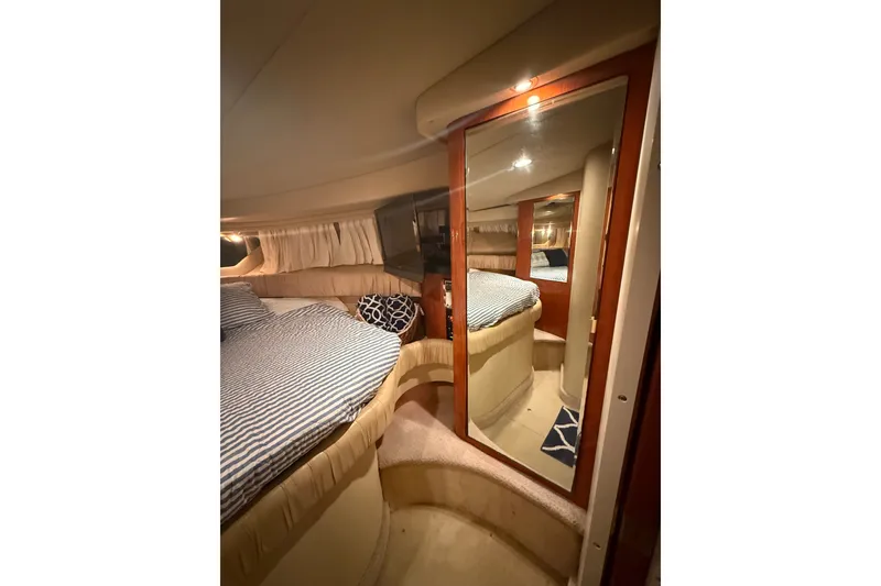 Slide: The Image of Cozy interior cabin of 2001 Sea Ray 380 Sundancer with bed and mirror. - 14