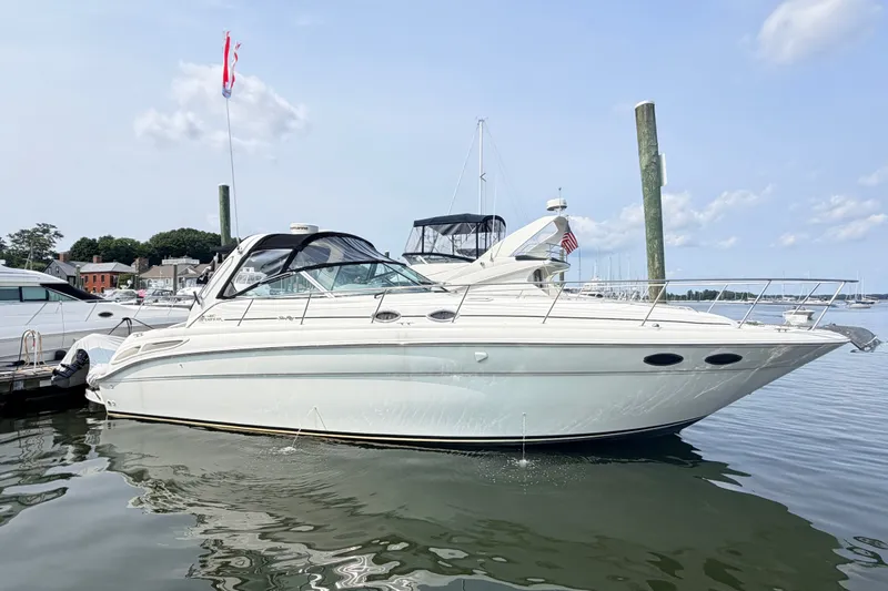 Slide: The Image of 2001 Sea Ray 380 Sundancer yacht docked in a marina under a clear sky. - 1