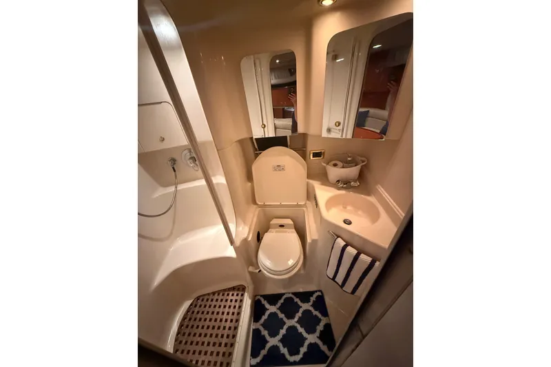 Slide: The Image of Bathroom interior of 2001 Sea Ray 380 Sundancer yacht, featuring shower, toilet, and sink. - 16