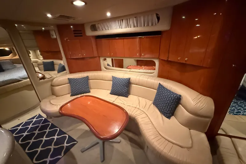 Slide: The Image of Luxurious interior of 2001 Sea Ray 380 Sundancer yacht with plush seating and wooden cabinetry. - 8