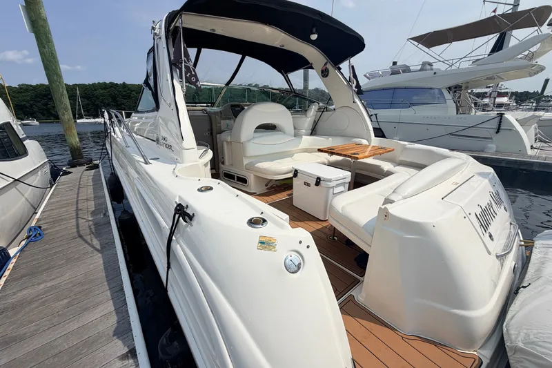 Slide: The Image of 2001 Sea Ray 380 Sundancer yacht docked, featuring spacious seating and elegant design. - 2