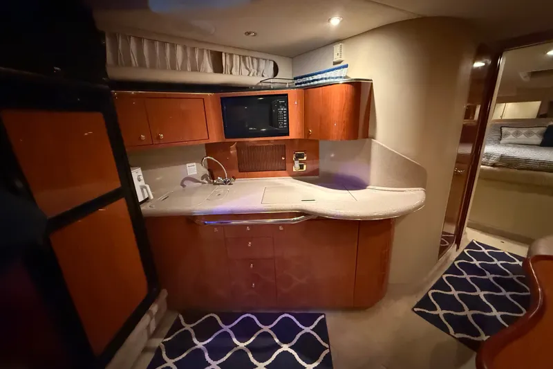 Slide: The Image of Luxurious 2001 Sea Ray 380 Sundancer yacht interior with modern kitchen amenities. - 7