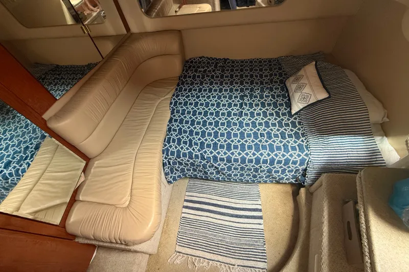 Slide: The Image of Interior cabin of 2001 Sea Ray 380 Sundancer with blue patterned bedding. - 11
