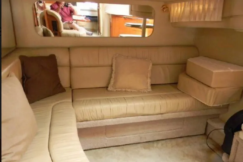 Slide: The Image of Interior of 2001 Sea Ray 380 Sundancer yacht with beige seating and cushions. - 10