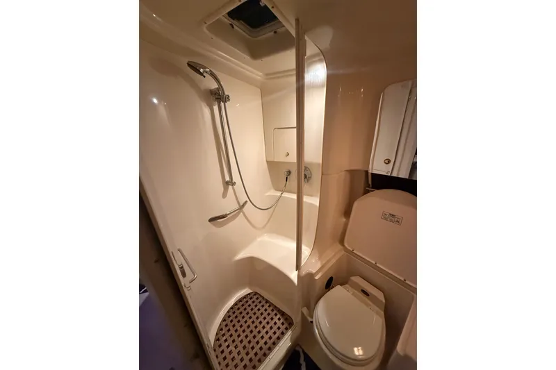 Slide: The Image of Bathroom interior of 2001 Sea Ray 380 Sundancer yacht, featuring shower and toilet. - 15