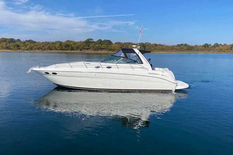 The Image of 2001 Sea Ray 380 Sundancer yacht on calm water under clear blue sky. - 0