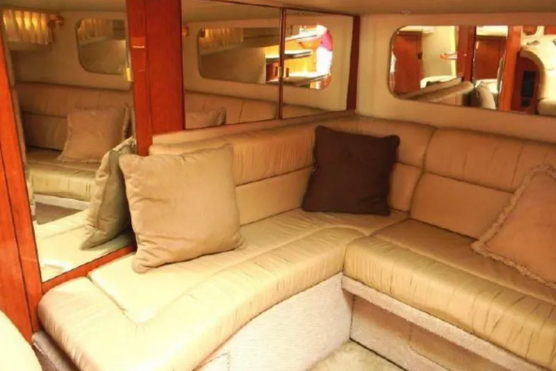 Slide: The Image of Luxurious interior of 2001 Sea Ray 380 Sundancer yacht with beige seating and cushions. - 9