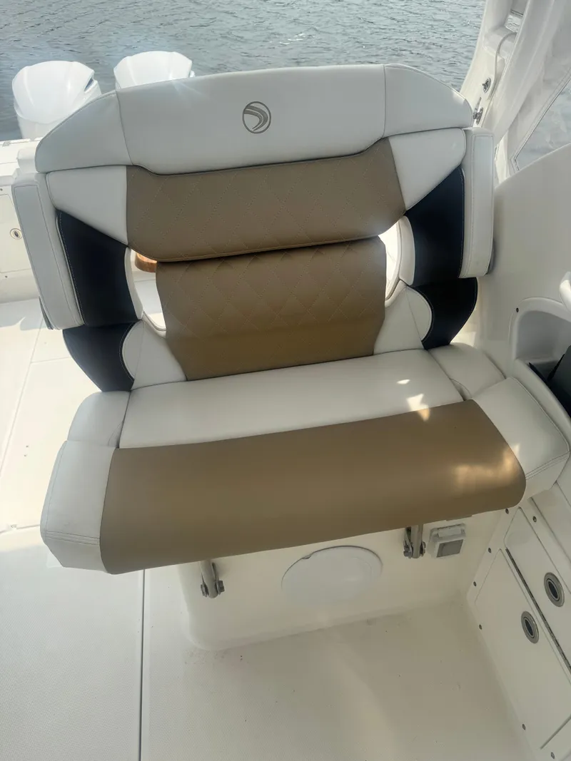 Slide: The Image of A luxurious, cushioned seat on a boat with a white and brown design. - 23