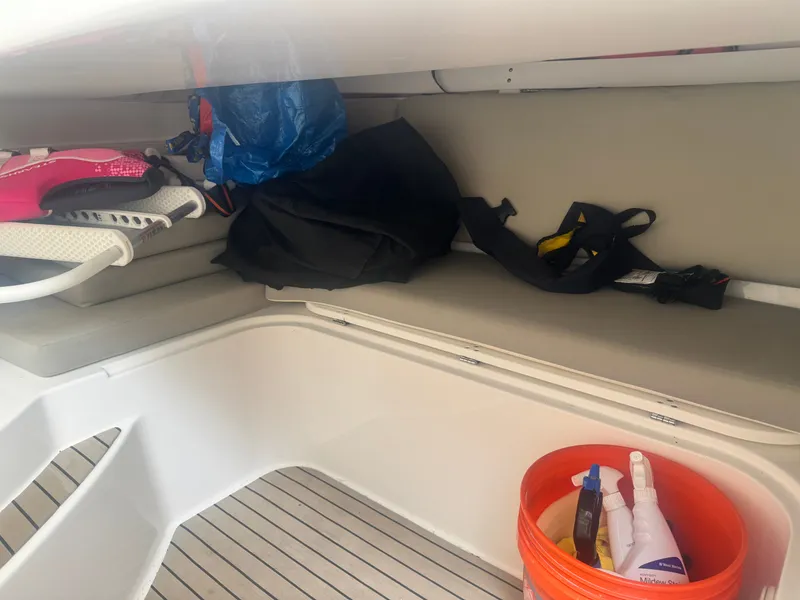Slide: The Image of The interior of a 2018 Edgewater 280CX Crossover with a bench seat and various items. - 18
