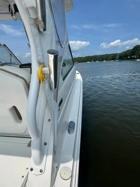 Slide: The Image of A 2018 Edgewater 280CX Crossover on calm water with a blue sky. - 16