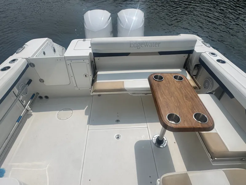 Slide: The Image of The image shows the cockpit of a 2018 Edgewater 280CX Crossover with a wooden table and seating. - 13