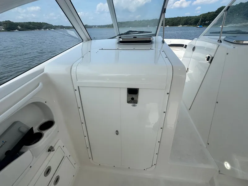 Slide: The Image of The image shows the cockpit of a 2018 Edgewater 280CX Crossover with white interior. - 22