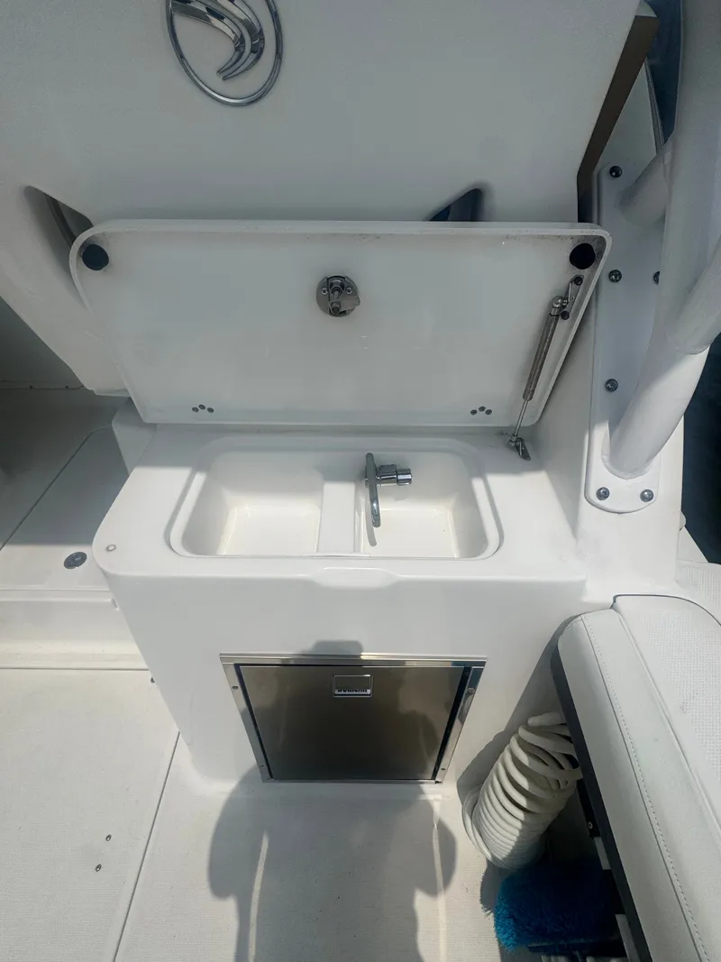 Slide: The Image of A sink with a faucet and storage below on a boat. - 20