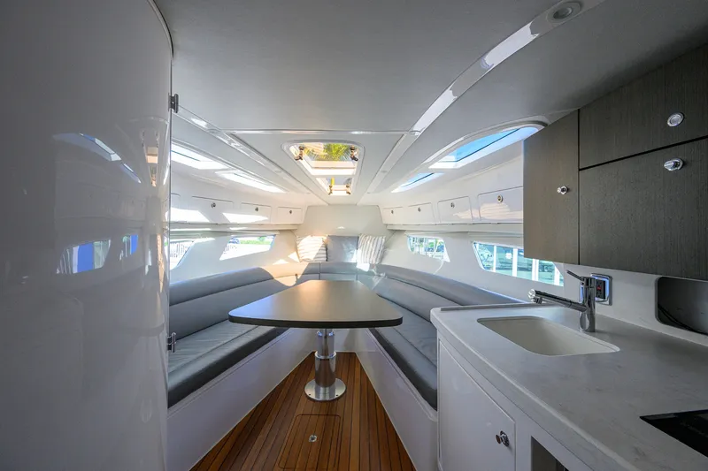 Slide: The Image of Luxurious interior of 2022 Intrepid 409 Valor yacht with modern seating and kitchenette. - 58