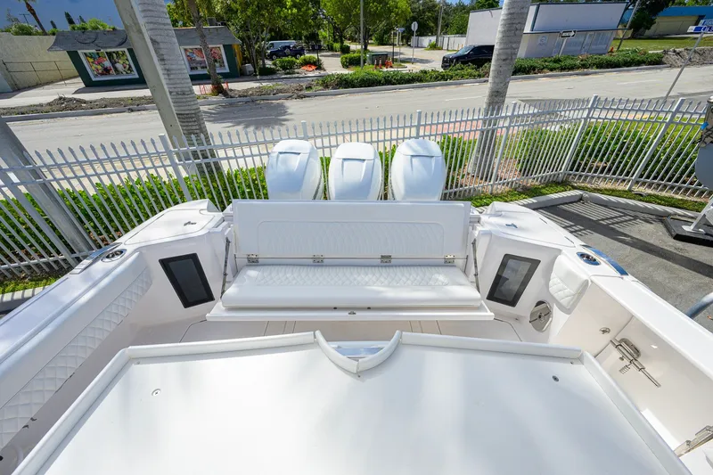 Slide: The Image of 2022 Intrepid 409 Valor boat with triple engines and spacious seating area. - 33