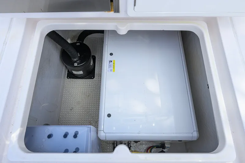 Slide: The Image of 2022 Intrepid 409 Valor boat compartment showcasing internal components and storage space. - 49