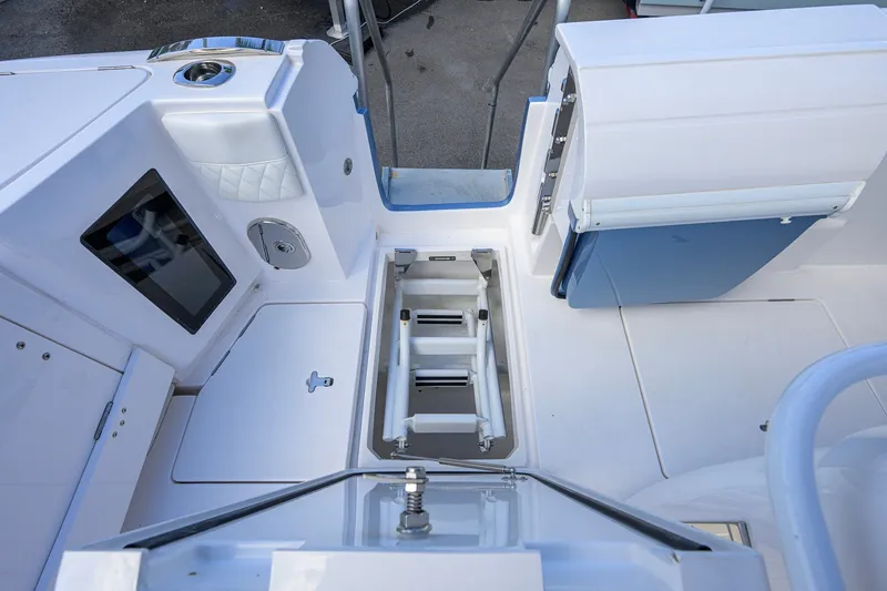 Slide: The Image of 2022 Intrepid 409 Valor boat interior with storage compartment and seating area. - 45