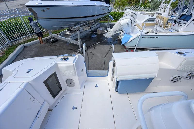 Slide: The Image of 2022 Intrepid 409 Valor boat interior with docked vessels in background. - 43