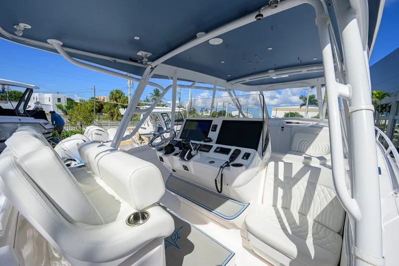 Slide: The Image of 2022 Intrepid 409 Valor boat interior with modern helm and seating. - 19