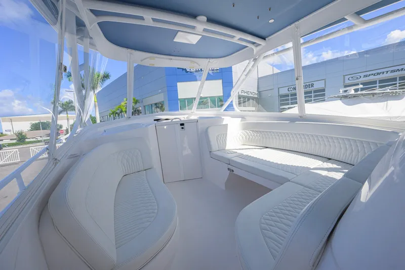 Slide: The Image of Luxurious interior of 2022 Intrepid 409 Valor boat with white seating and panoramic windows. - 23