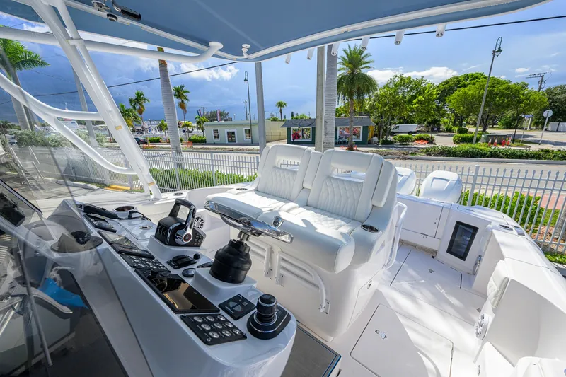 Slide: The Image of 2022 Intrepid 409 Valor boat cockpit with modern controls and plush seating. - 20