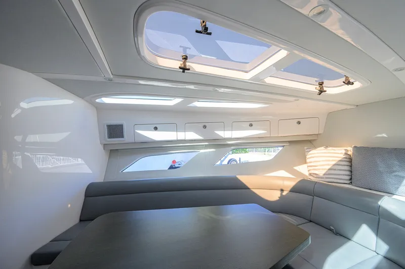 Slide: The Image of Interior of 2022 Intrepid 409 Valor yacht with skylight and modern seating area. - 60