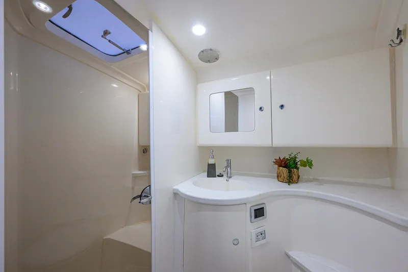 Slide: The Image of Luxurious bathroom interior of 2022 Intrepid 409 Valor yacht, featuring modern fixtures and skylight. - 70