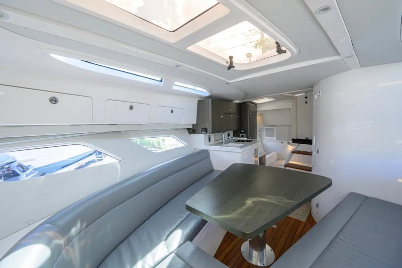 Slide: The Image of Luxurious interior of 2022 Intrepid 409 Valor yacht with modern seating and kitchen area. - 63