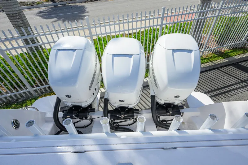 Slide: The Image of Triple outboard motors on a 2022 Intrepid 409 Valor boat, viewed from above. - 54