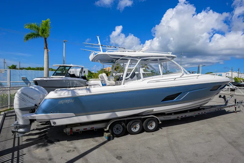 Slide: The Image of 2022 Intrepid 409 Valor boat on trailer under clear blue sky. - 7