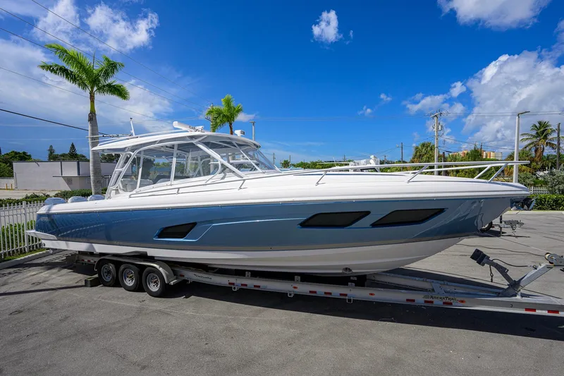 Slide: The Image of 2022 Intrepid 409 Valor boat on trailer under clear blue sky. - 0