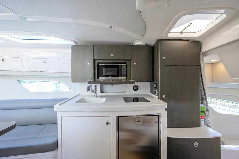 Slide: The Image of Modern kitchen interior of 2022 Intrepid 409 Valor boat, featuring sleek cabinetry and appliances. - 66