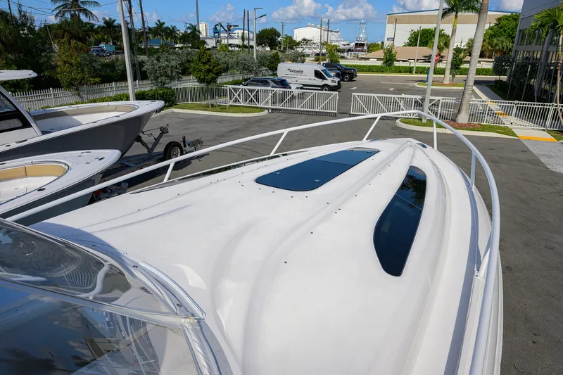 Slide: The Image of 2022 Intrepid 409 Valor boat deck view in a marina setting. - 12