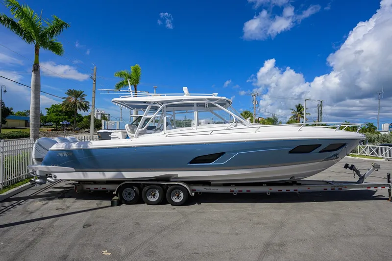 Slide: The Image of 2022 Intrepid 409 Valor boat on trailer under clear blue sky. - 6