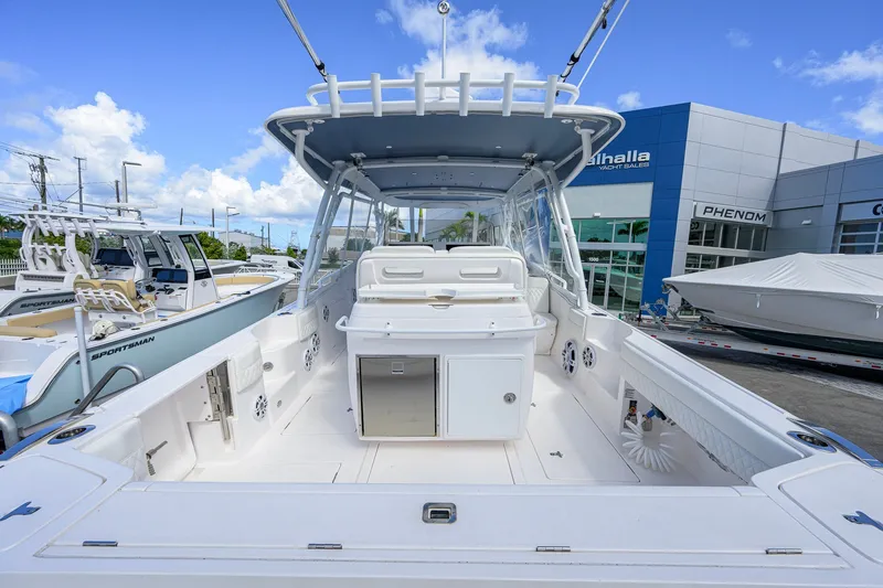 Slide: The Image of 2022 Intrepid 409 Valor boat at dealership, showcasing spacious deck and modern design. - 37
