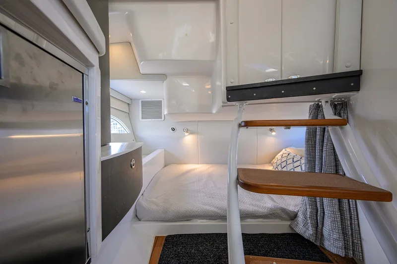 Slide: The Image of Cozy cabin interior of 2022 Intrepid 409 Valor with bed and wooden steps. - 71