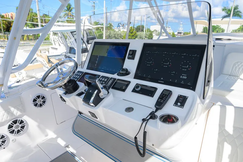 Slide: The Image of 2022 Intrepid 409 Valor boat cockpit with advanced navigation and control systems. - 18