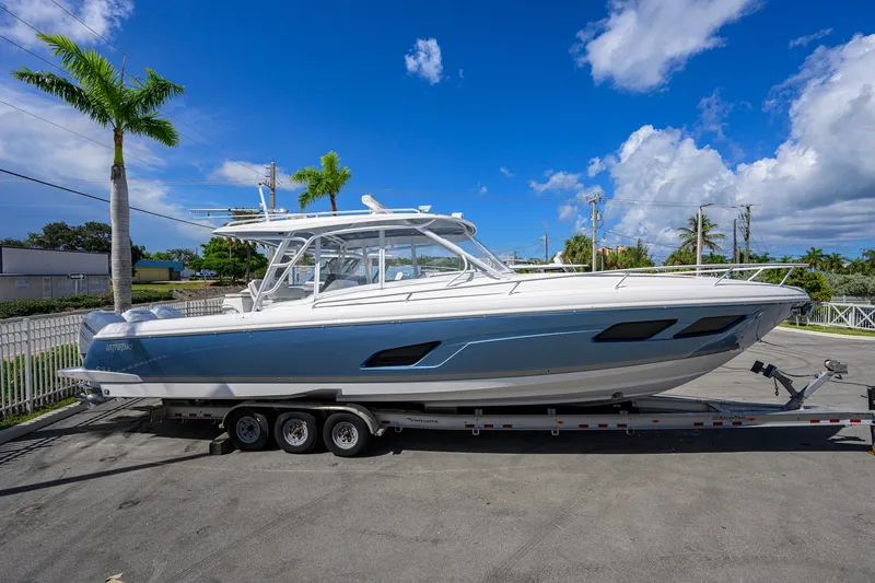 Slide: The Image of 2022 Intrepid 409 Valor boat on trailer under clear blue sky. - 5