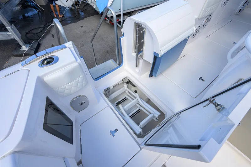 Slide: The Image of 2022 Intrepid 409 Valor boat interior with open storage compartments and seating area. - 44
