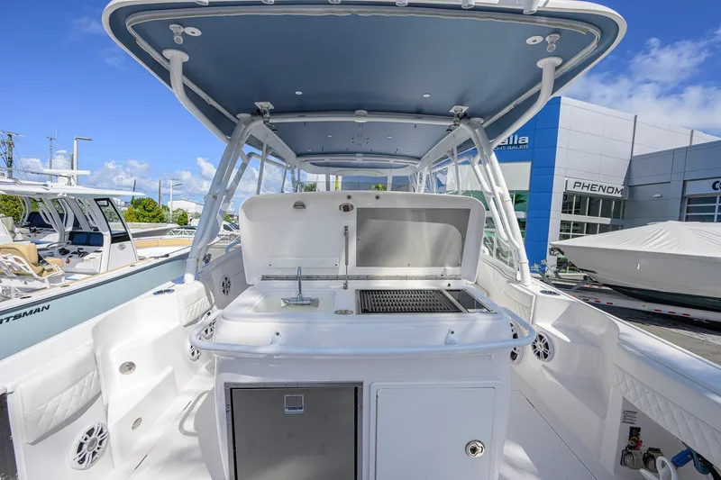 Slide: The Image of 2022 Intrepid 409 Valor boat with outdoor kitchen and sleek design at a marina. - 41