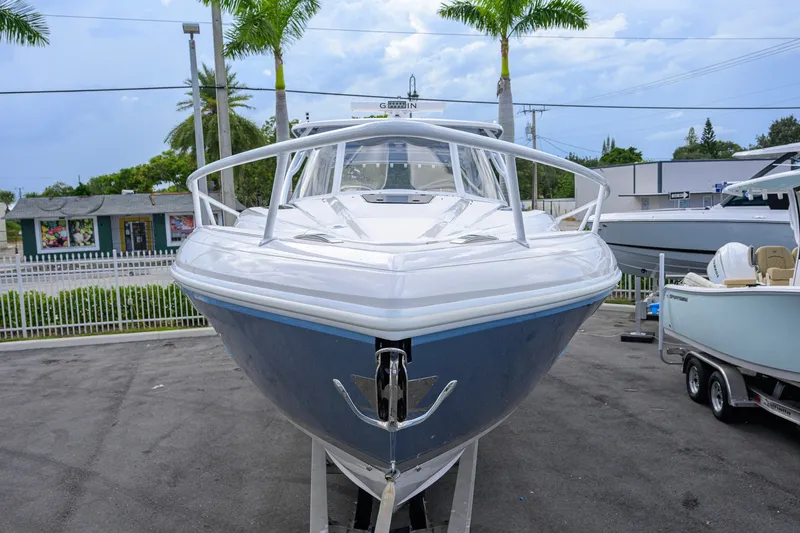 Slide: The Image of 2022 Intrepid 409 Valor boat displayed outdoors with palm trees in the background. - 3