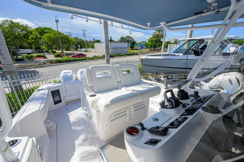 Slide: The Image of 2022 Intrepid 409 Valor boat interior with white seating and control panel. - 21