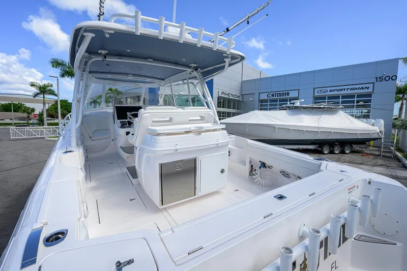 Slide: The Image of 2022 Intrepid 409 Valor boat displayed at a dealership, showcasing spacious deck and modern design. - 39