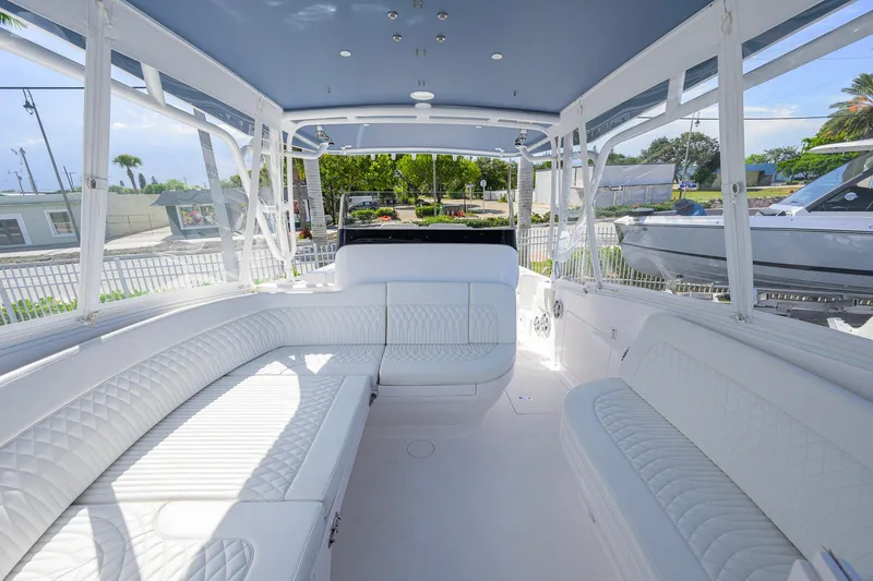 Slide: The Image of Luxurious interior of 2022 Intrepid 409 Valor boat with white seating and panoramic windows. - 28