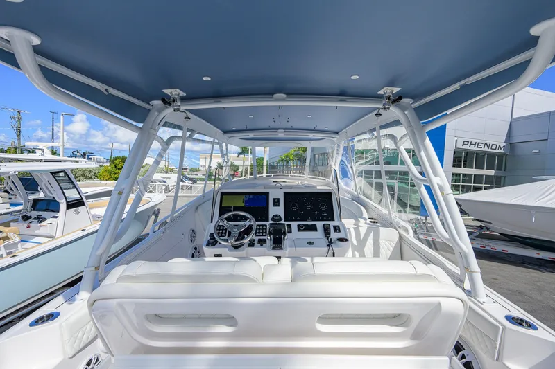Slide: The Image of 2022 Intrepid 409 Valor boat cockpit with modern navigation system and luxurious seating. - 13
