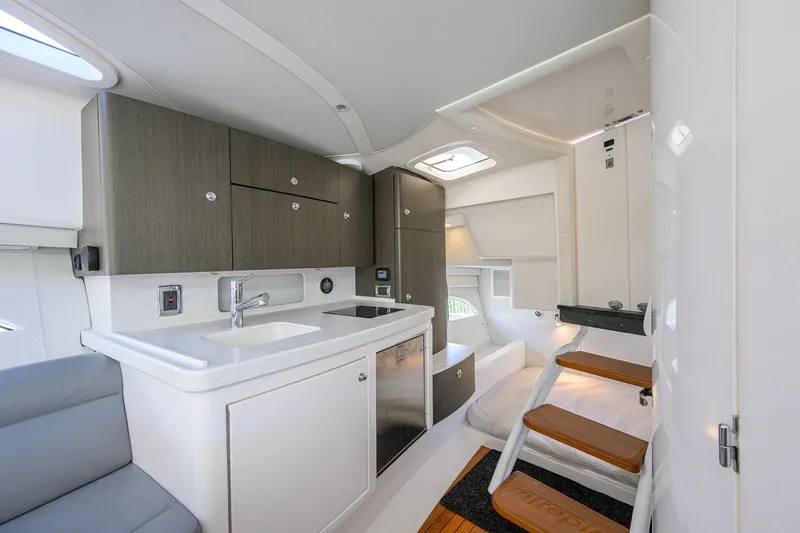 Slide: The Image of Luxurious interior of 2022 Intrepid 409 Valor boat featuring modern kitchen and cozy seating area. - 65